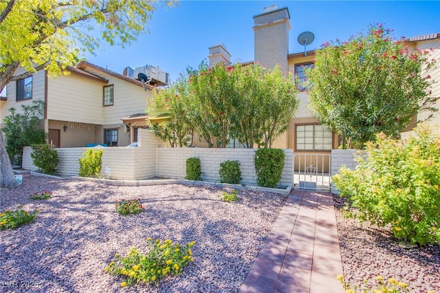 3249 Dayflower St Unit C, Las Vegas, NV 89121 - view of front of home featuring stucco siding, fence, and a gate