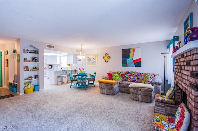 3249 Dayflower St Unit C, Las Vegas, NV 89121 - carpeted living room featuring a brick fireplace and visible vents