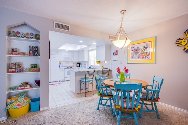 3249 Dayflower St Unit C, Las Vegas, NV 89121 - dining room featuring light tile patterned floors, visible vents, baseboards, and light carpet