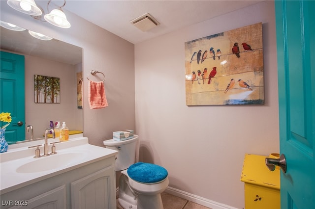3249 Dayflower St Unit C, Las Vegas, NV 89121 - bathroom with toilet, vanity, visible vents, tile patterned floors, and baseboards