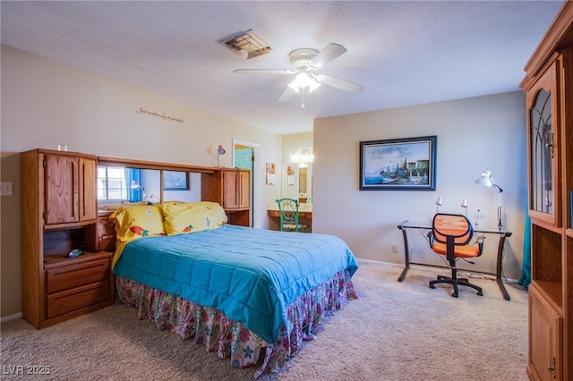 3249 Dayflower St Unit C, Las Vegas, NV 89121 - carpeted bedroom with ensuite bath, ceiling fan, baseboards, and visible vents