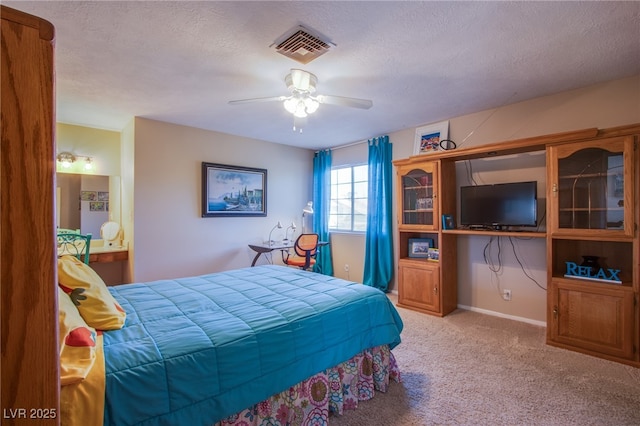 3249 Dayflower St Unit C, Las Vegas, NV 89121 - carpeted bedroom featuring ceiling fan, connected bathroom, visible vents, and a textured ceiling