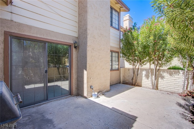3249 Dayflower St Unit C, Las Vegas, NV 89121 - property entrance with a patio area, stucco siding, and fence