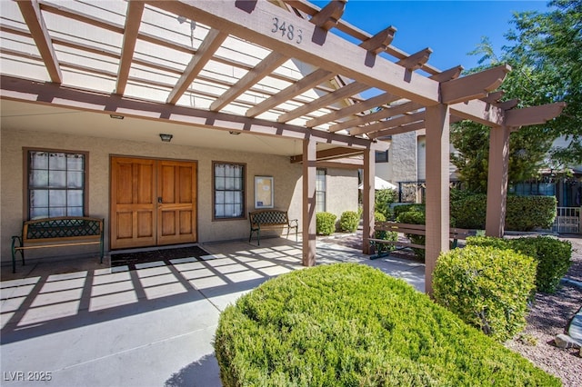 3249 Dayflower St Unit C, Las Vegas, NV 89121 - view of exterior entry featuring stucco siding and a pergola