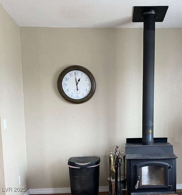room details with a wood stove and baseboards