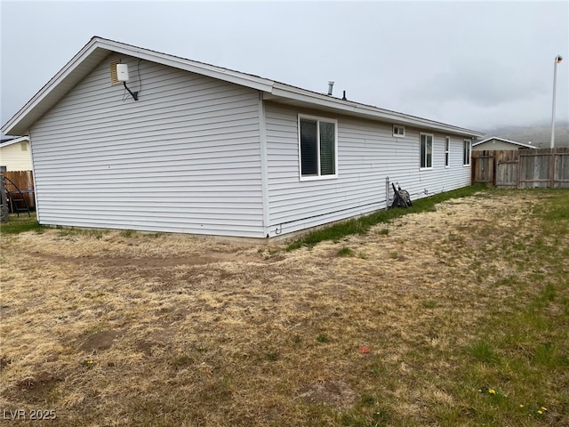 view of home's exterior with fence
