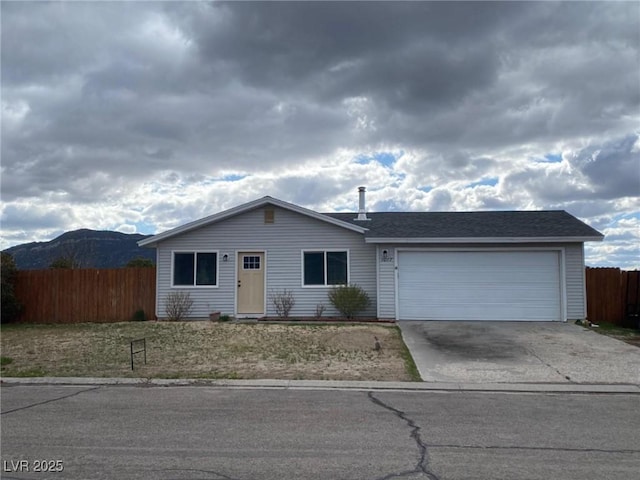 single story home with driveway, a garage, and fence