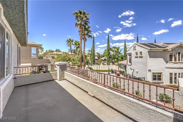 view of patio with a balcony and a residential view