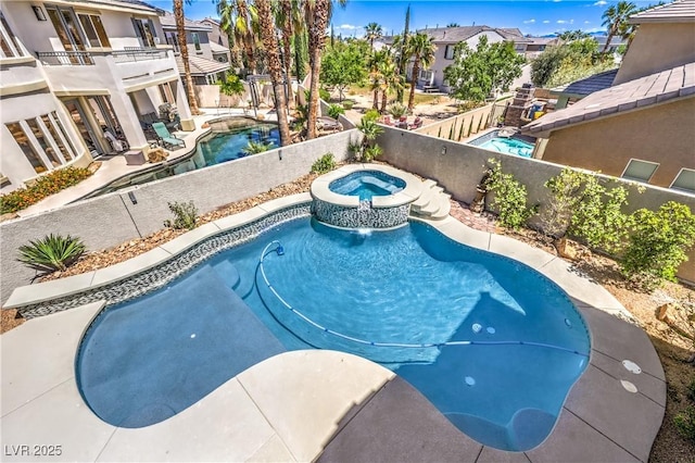 view of swimming pool featuring an in-ground hot tub, a fenced backyard, and a residential view