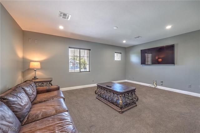 living area featuring dark carpet, recessed lighting, and baseboards