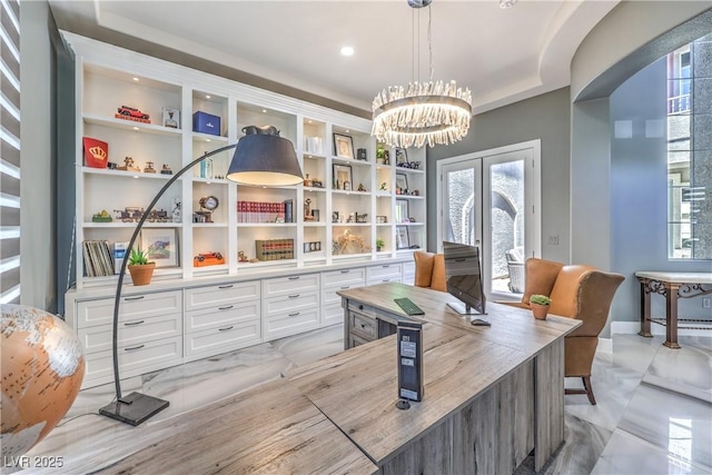 home office featuring a notable chandelier, french doors, and built in features