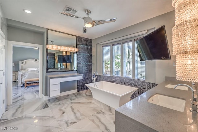 ensuite bathroom featuring recessed lighting, ensuite bathroom, visible vents, vanity, and a freestanding tub