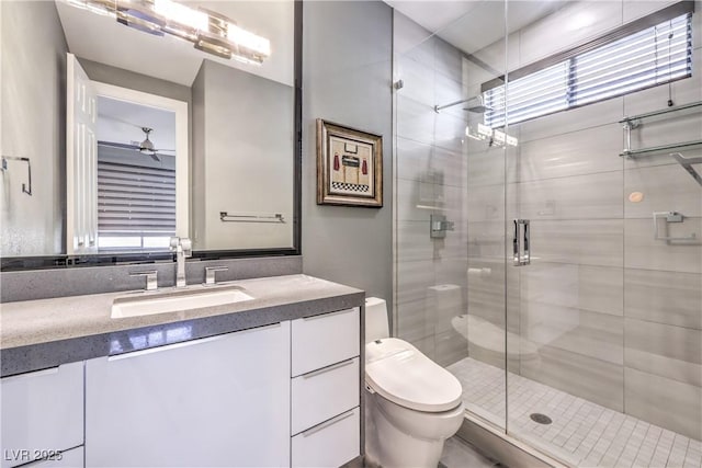 full bath featuring a shower stall, vanity, and toilet