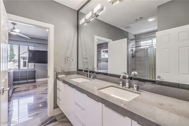 bathroom with double vanity, visible vents, a shower stall, and a sink