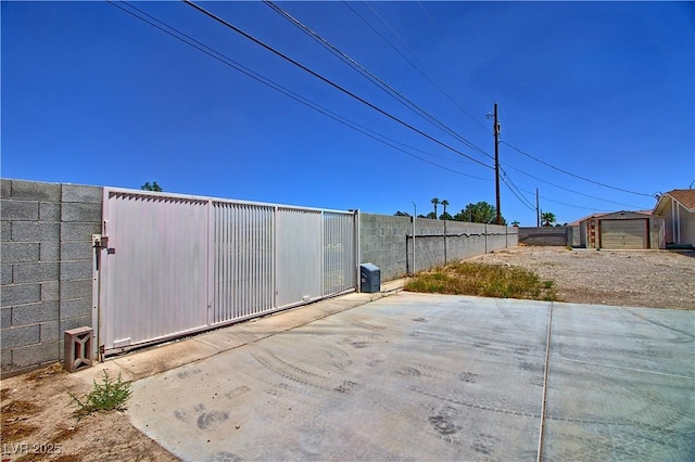gate featuring fence and a patio