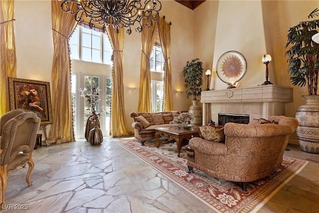 35 Ventana Canyon Dr, Las Vegas, NV 89113 - living area with a fireplace, a chandelier, stone tile floors, and a high ceiling
