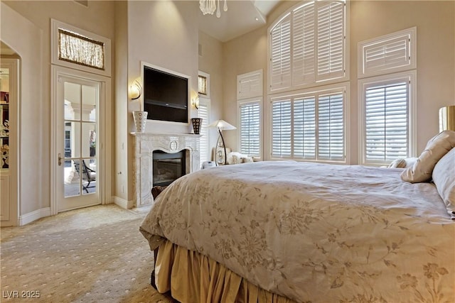 35 Ventana Canyon Dr, Las Vegas, NV 89113 - bedroom with a premium fireplace, baseboards, a high ceiling, carpet floors, and access to exterior