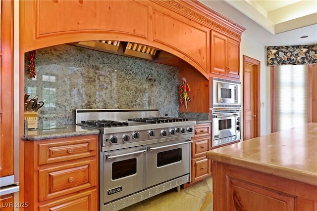 35 Ventana Canyon Dr, Las Vegas, NV 89113 - kitchen with brown cabinets, stainless steel appliances, and decorative backsplash