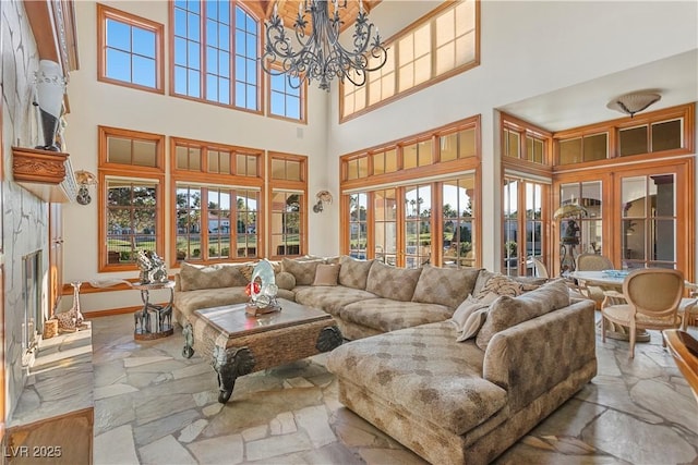 35 Ventana Canyon Dr, Las Vegas, NV 89113 - living area featuring a high ceiling, a chandelier, baseboards, and a healthy amount of sunlight