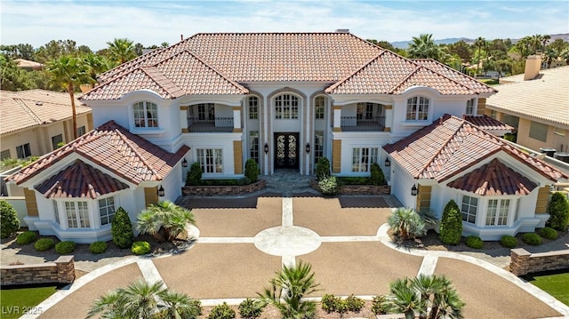 35 Ventana Canyon Dr, Las Vegas, NV 89113 - mediterranean / spanish-style house featuring a tiled roof, stucco siding, french doors, and a balcony