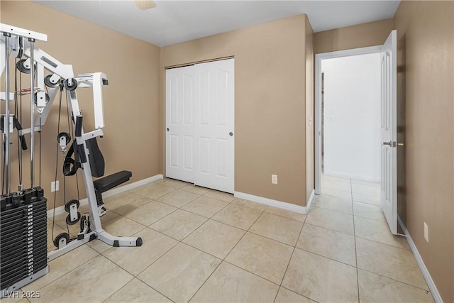 workout area with light tile patterned floors and baseboards