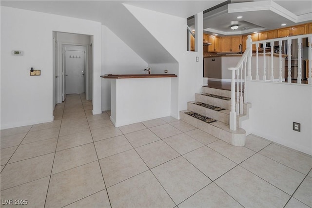 staircase featuring recessed lighting, baseboards, and tile patterned floors