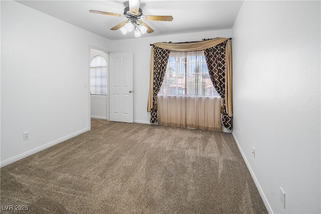carpeted spare room with ceiling fan, baseboards, and a healthy amount of sunlight