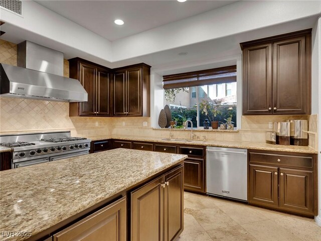 12056 Royal Dolnoch Ct, Las Vegas, NV 89141 - kitchen with a sink, stainless steel appliances, light stone counters, visible vents, and wall chimney exhaust hood