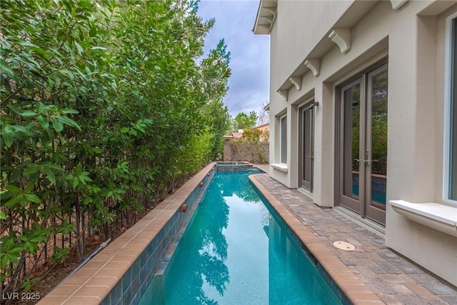 12056 Royal Dolnoch Ct, Las Vegas, NV 89141 - view of pool with a pool with connected hot tub, a fenced backyard, and french doors