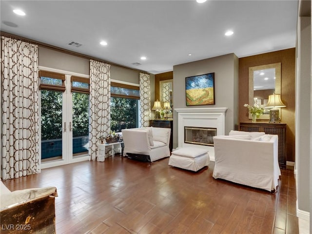 12056 Royal Dolnoch Ct, Las Vegas, NV 89141 - sitting room with wood finished floors, french doors, visible vents, a glass covered fireplace, and recessed lighting