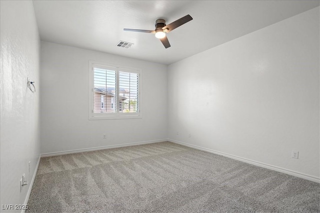 spare room featuring carpet, baseboards, a ceiling fan, and visible vents