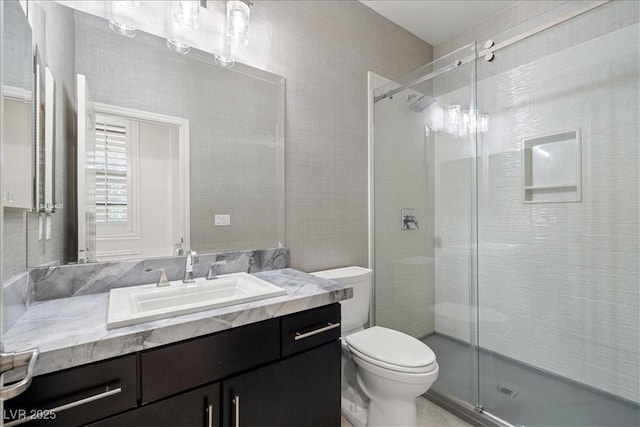full bath featuring vanity, toilet, and a shower stall