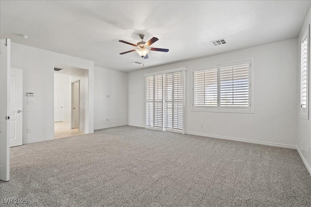 unfurnished room with light colored carpet, ceiling fan, baseboards, and visible vents