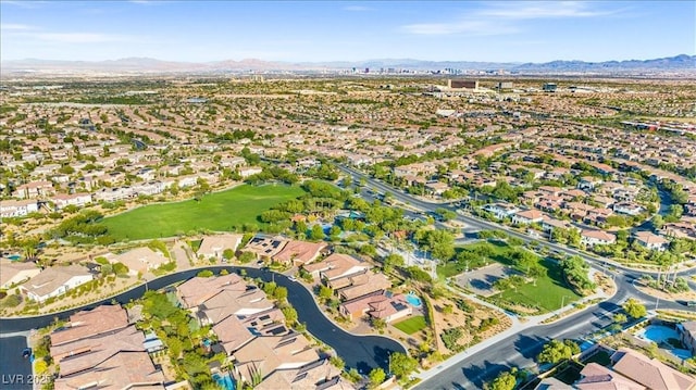 view of property location with a mountain backdrop and nearby suburban area