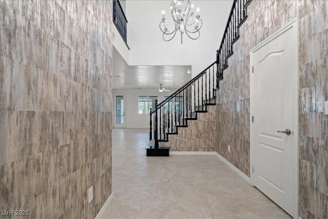 entrance foyer with stairway and a notable chandelier