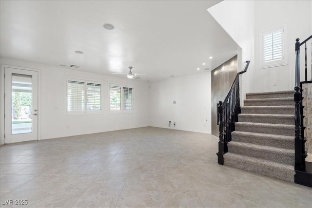 unfurnished living room with visible vents, recessed lighting, stairway, ceiling fan, and light tile patterned floors