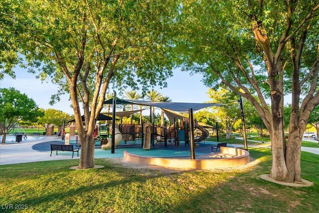 view of property's community with playground community and a yard