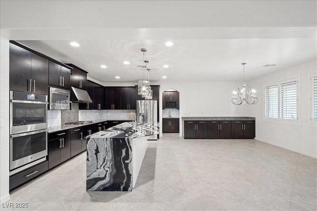 kitchen featuring backsplash, stainless steel appliances, a chandelier, and recessed lighting