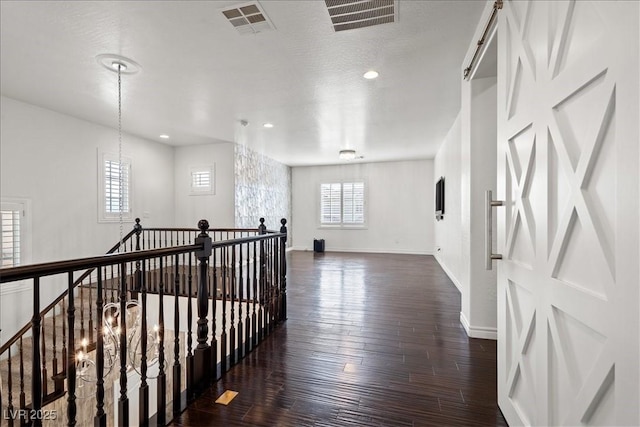 corridor featuring recessed lighting, baseboards, visible vents, and dark wood finished floors