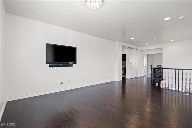unfurnished living room with wood finished floors, baseboards, and recessed lighting