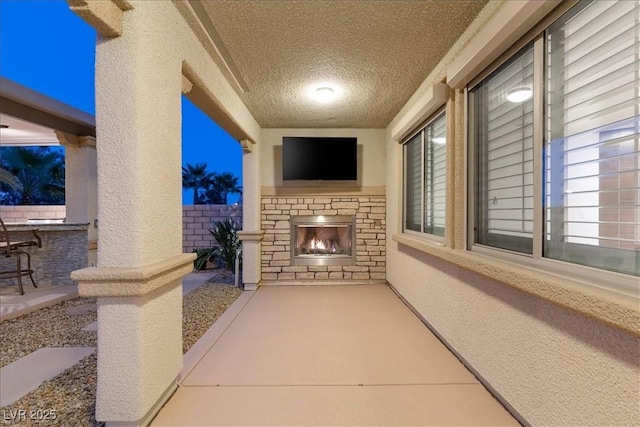 view of patio / terrace featuring an outdoor stone fireplace