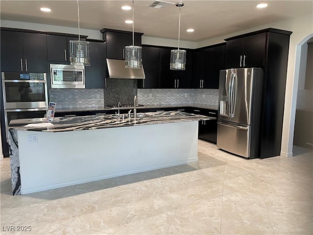 kitchen featuring stainless steel appliances, hanging light fixtures, dark cabinetry, and recessed lighting