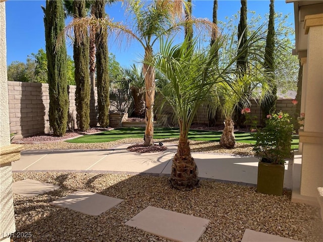 fenced backyard with a patio area