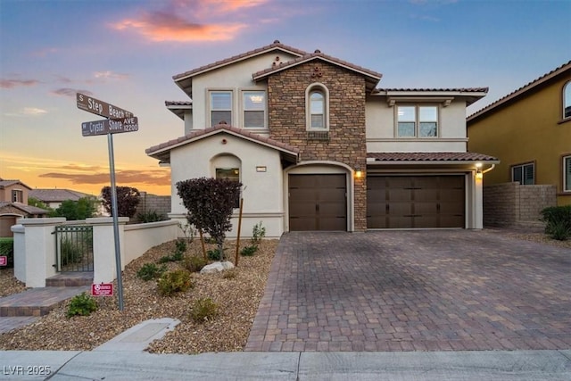 view of front of property with an attached garage, stucco siding, a tile roof, and fence