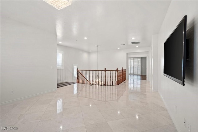 unfurnished room featuring visible vents, baseboards, and recessed lighting