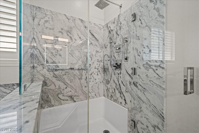 bathroom with a marble finish shower