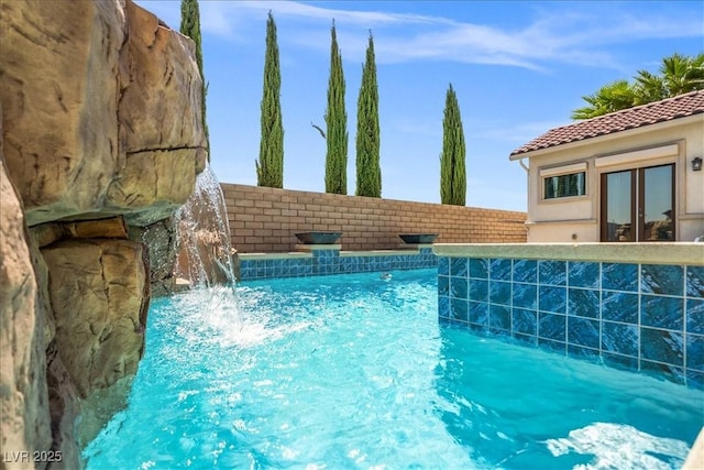 pool featuring a fenced backyard