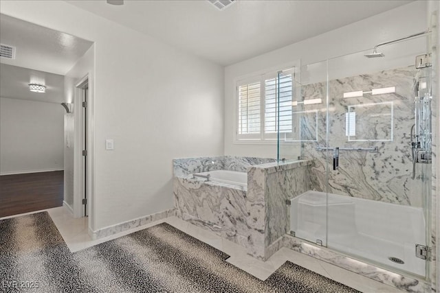 full bath with a marble finish shower, baseboards, visible vents, and a bath