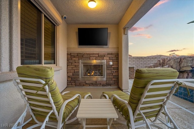 view of patio featuring an outdoor stone fireplace