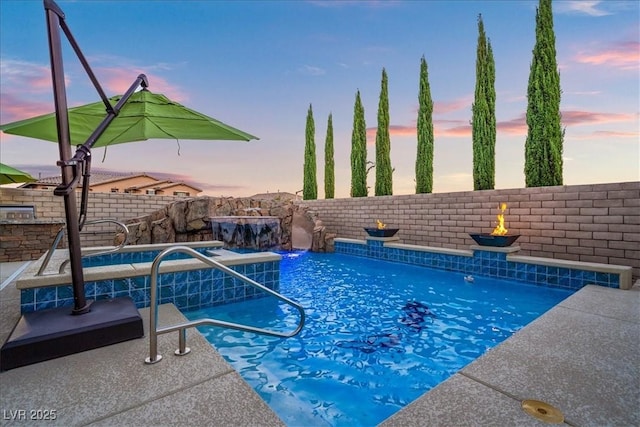 pool at dusk with a fenced in pool and a fenced backyard